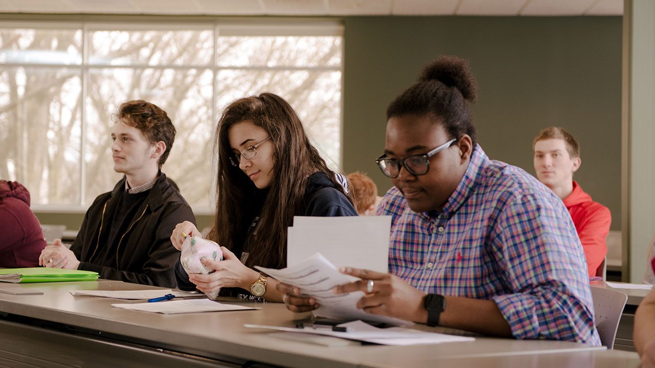 Students sitting in class listening to lecture on Human Resources.