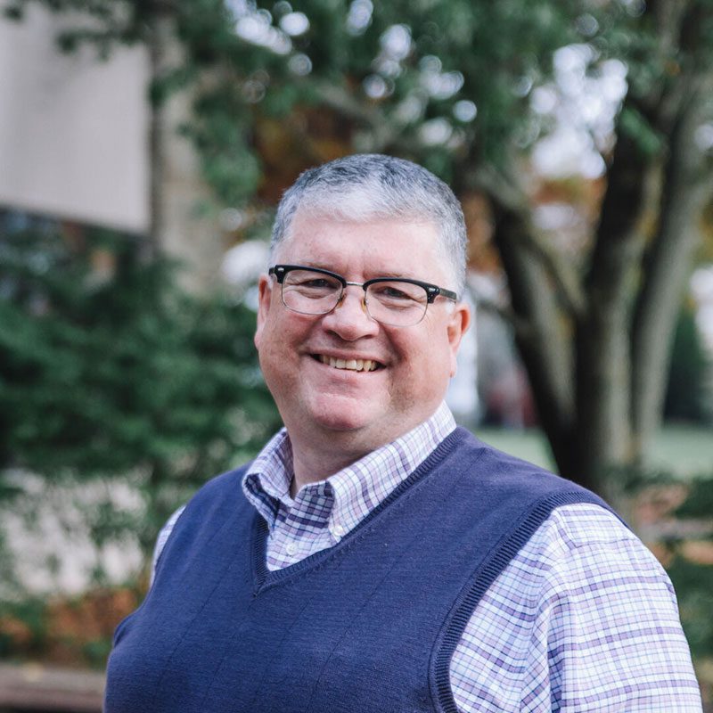 Professor Doug Gaerte standing outside on Houghton's campus.