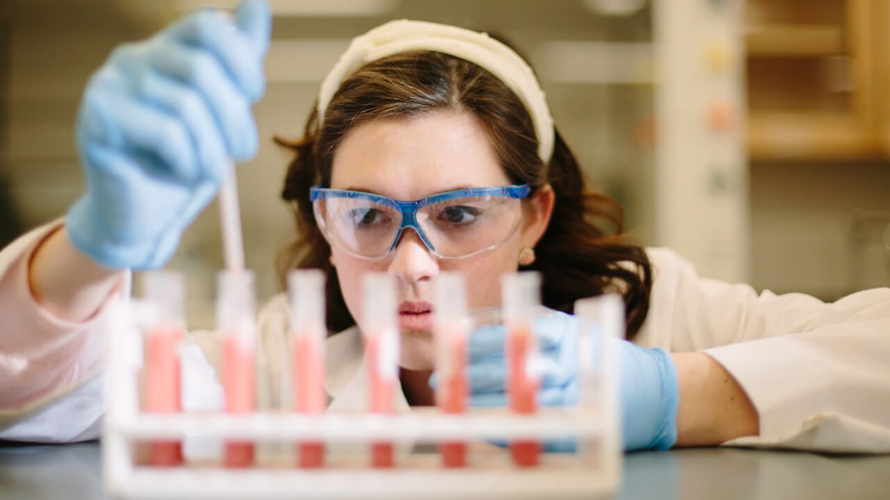 chemistry student conducting research in the lab
