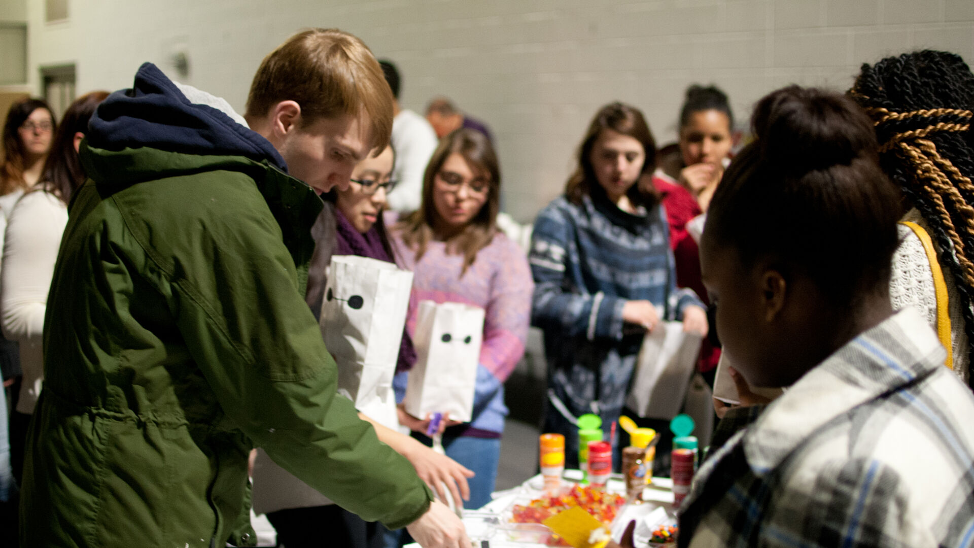 students fill goodie bags at table during accepted students weekend