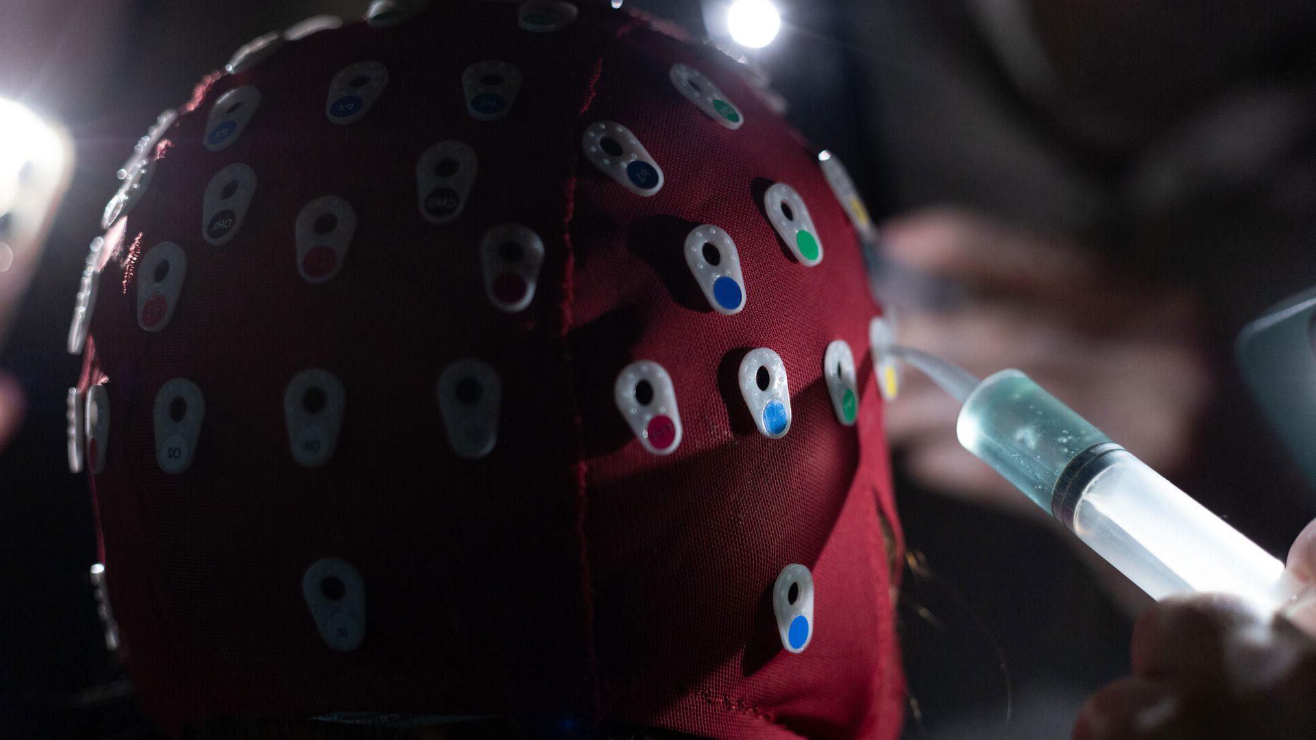 Houghton student adding gel to psychology cap during eeg scan lab exercise in a Psychology class.