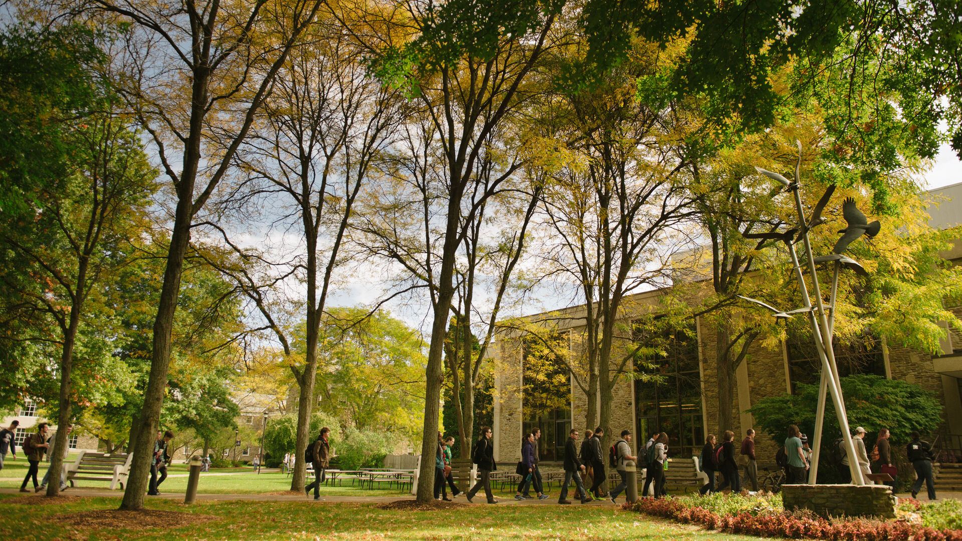 Students walking on campus on a beautiful fall day