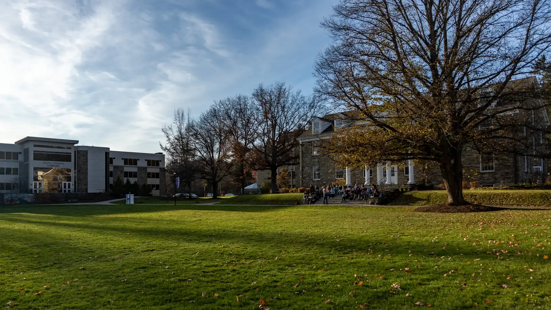 View across the quad of a class taking place outside on Houghton's campus.