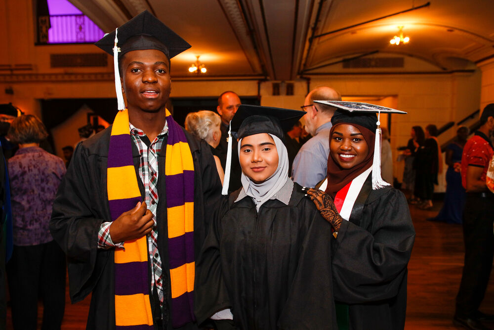 three students smile at camera at Houghton Buffalo commencement