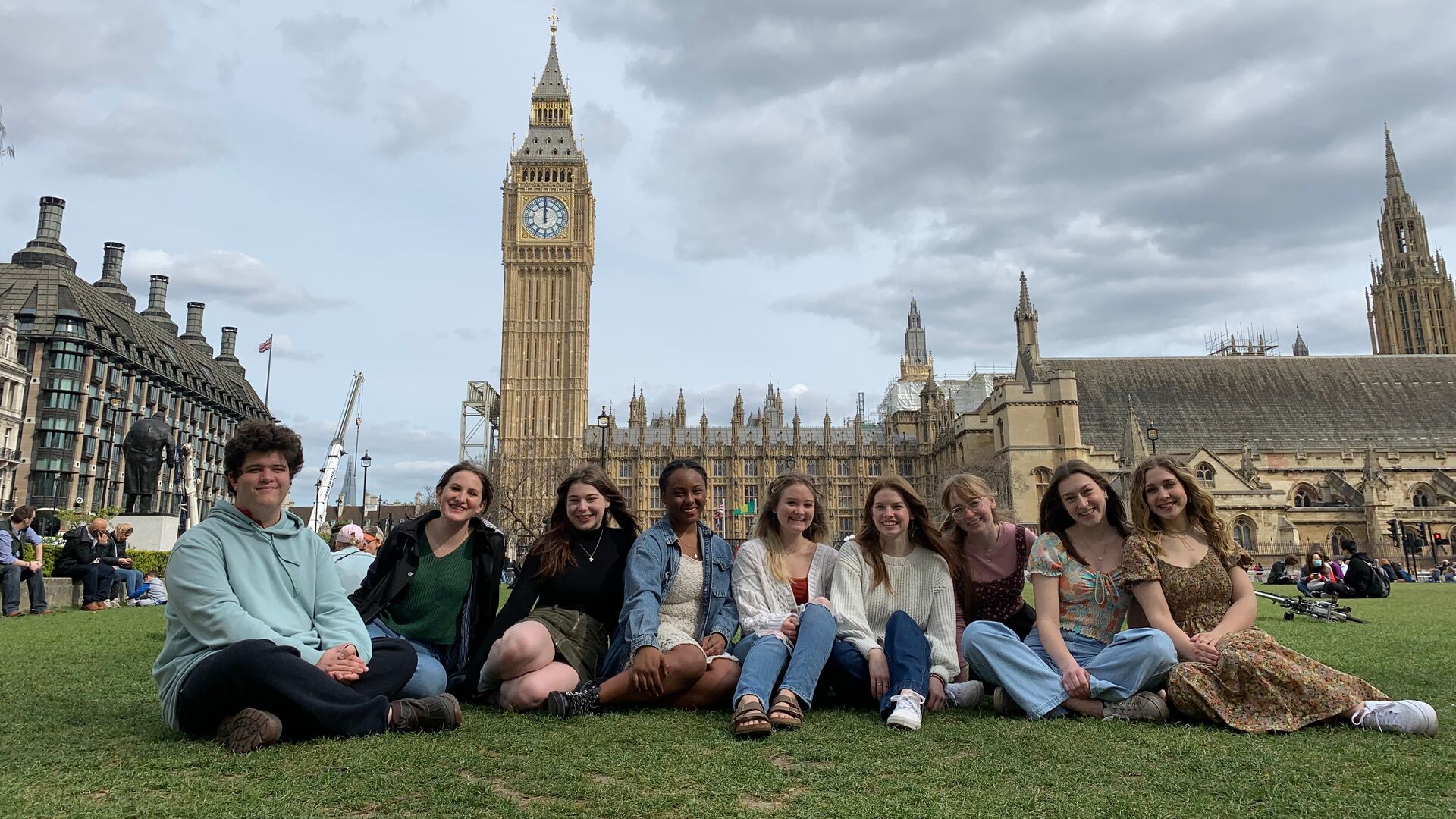 Students sitting on the lawn in front of Big Ben in London