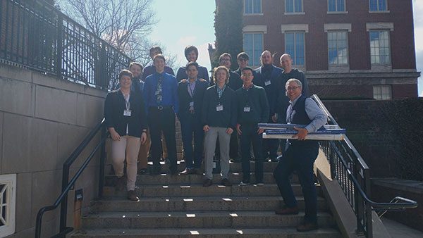 Houghton physics students and professors standing on steps.