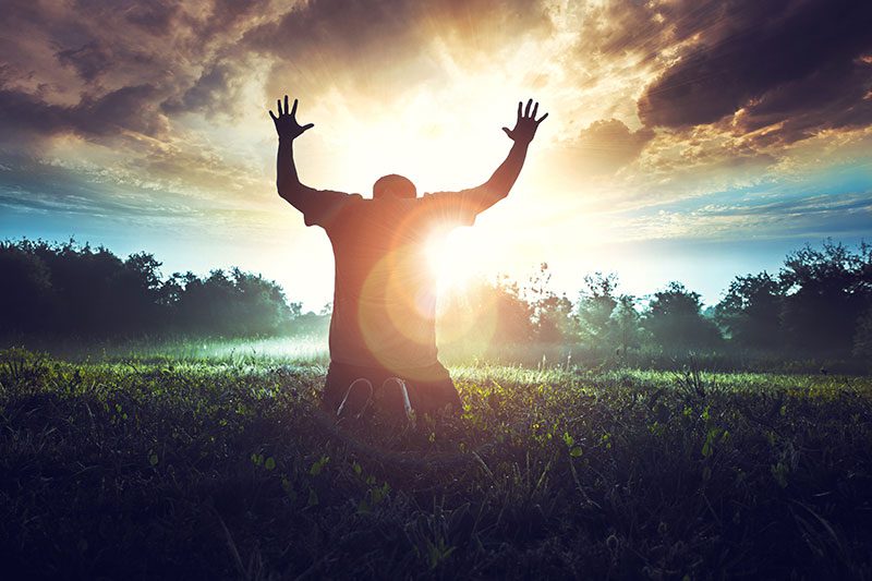 Man lifting his hands to the sky in praise