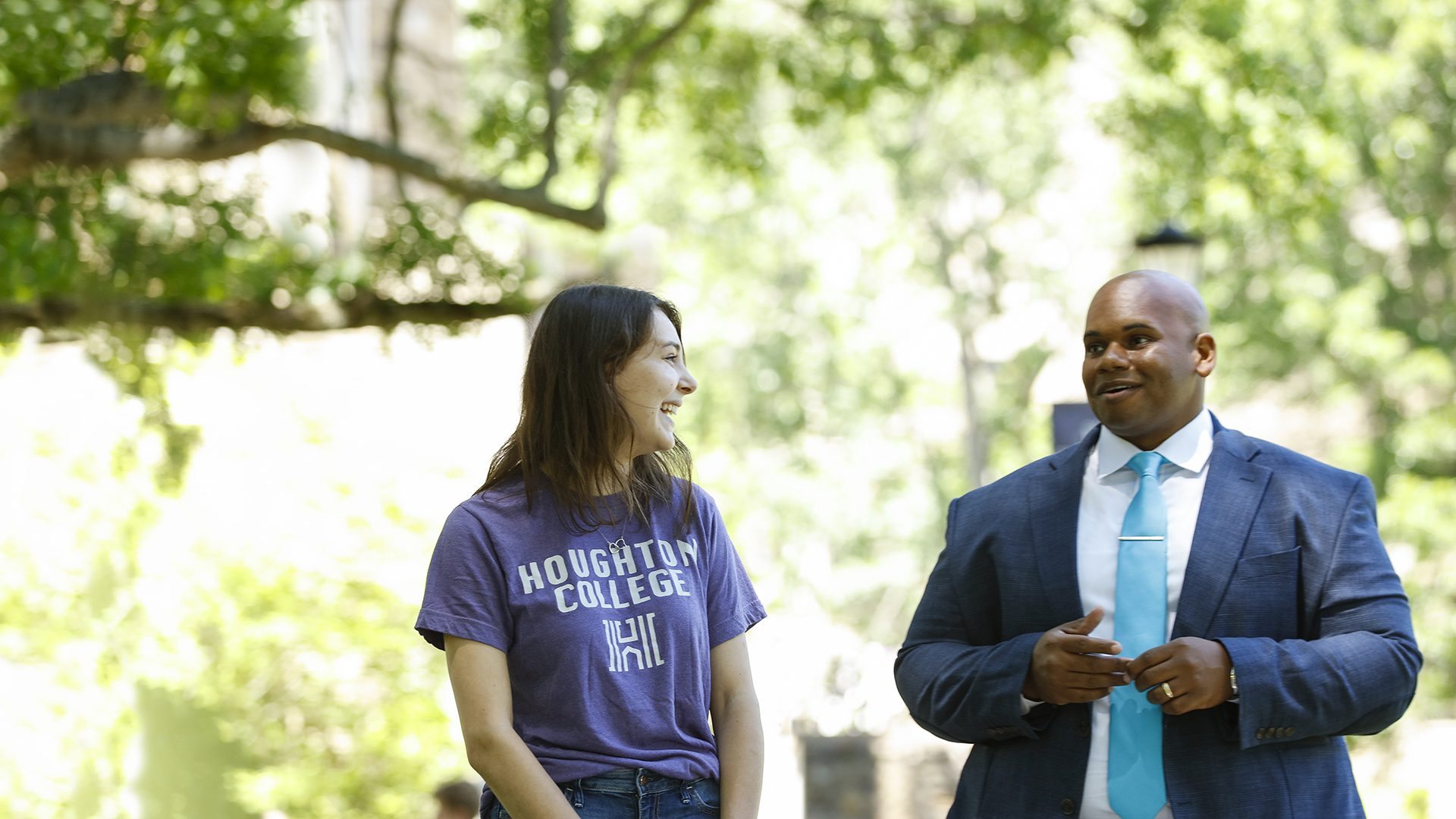President Lewis speaking with a student