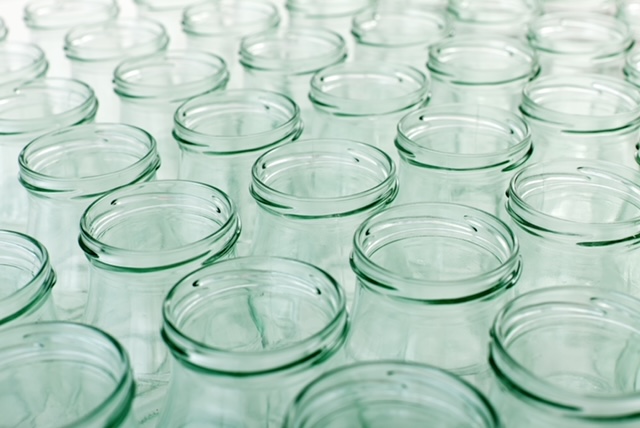 Empty glass jars lined up in rows