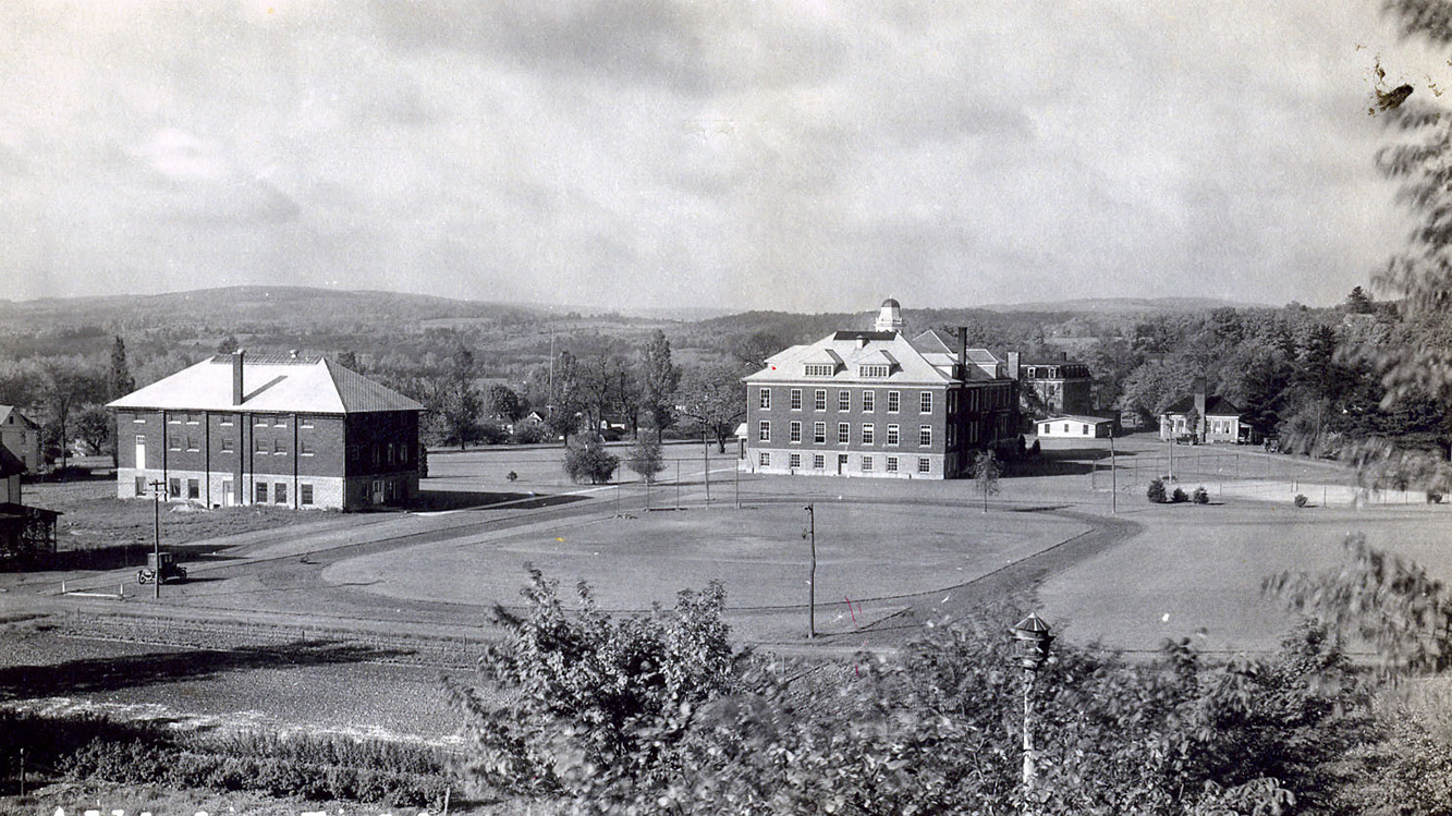 Historic black and white image of athletic field and quad of Houghton University.