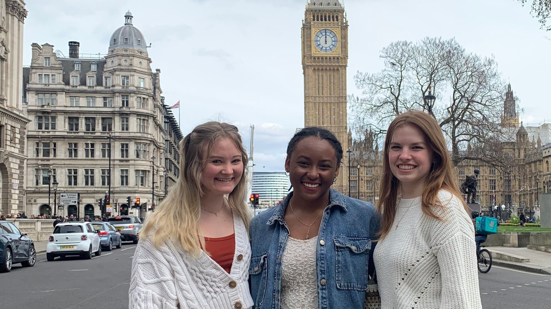 Three students standing in the street in front of Big Ben as a part of the London Honors program.