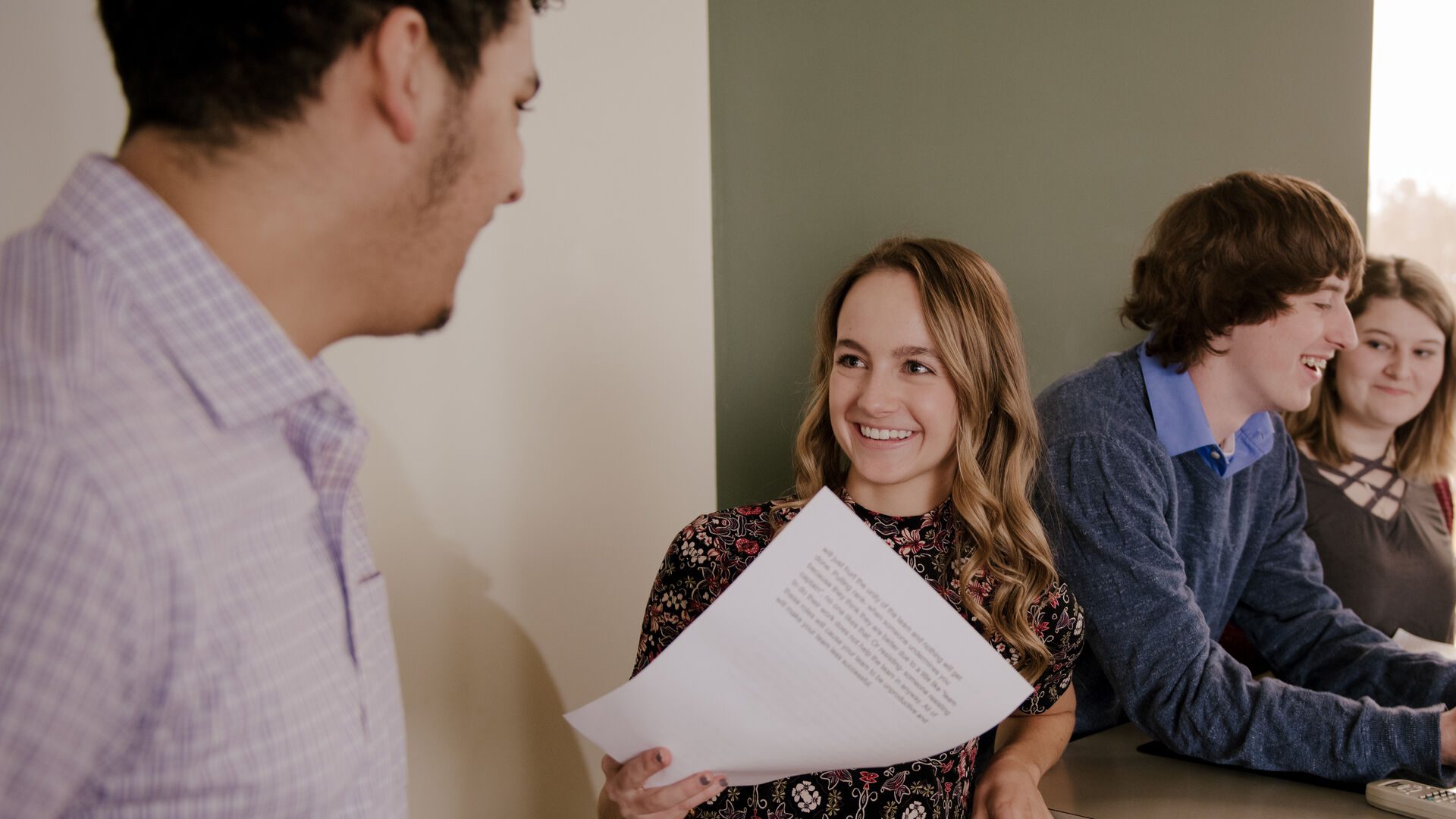 Houghton students at the front of class presenting.