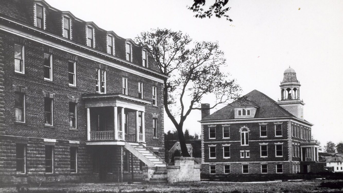 Historic black and white photo of Fancher Hall next to a dormitory building at Houghton University.
