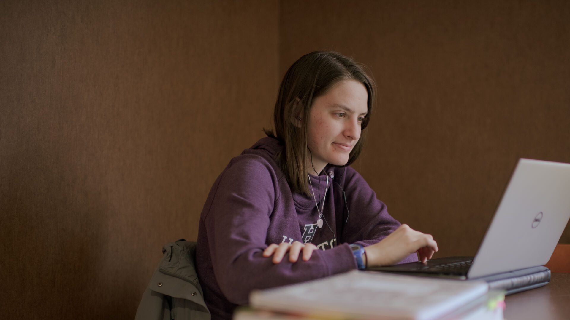 Houghton student sitting at laptop.