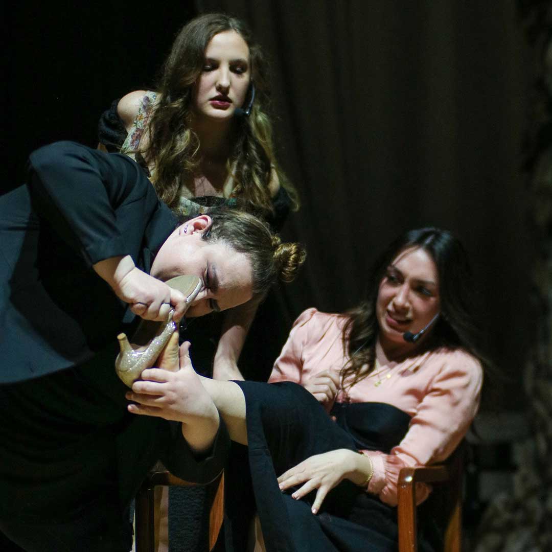 Three Houghton students acting on stage during the Lyric Theatre production of Into the Woods.