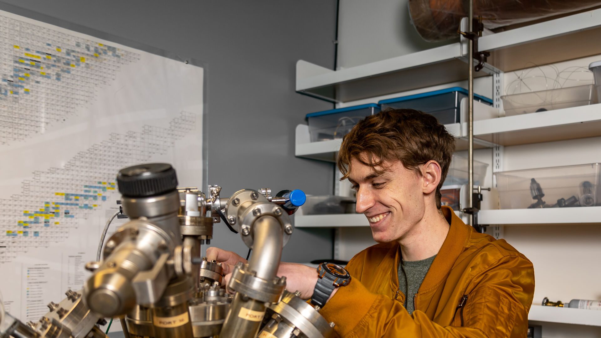 Houghton University student working with instruments in physics lab.