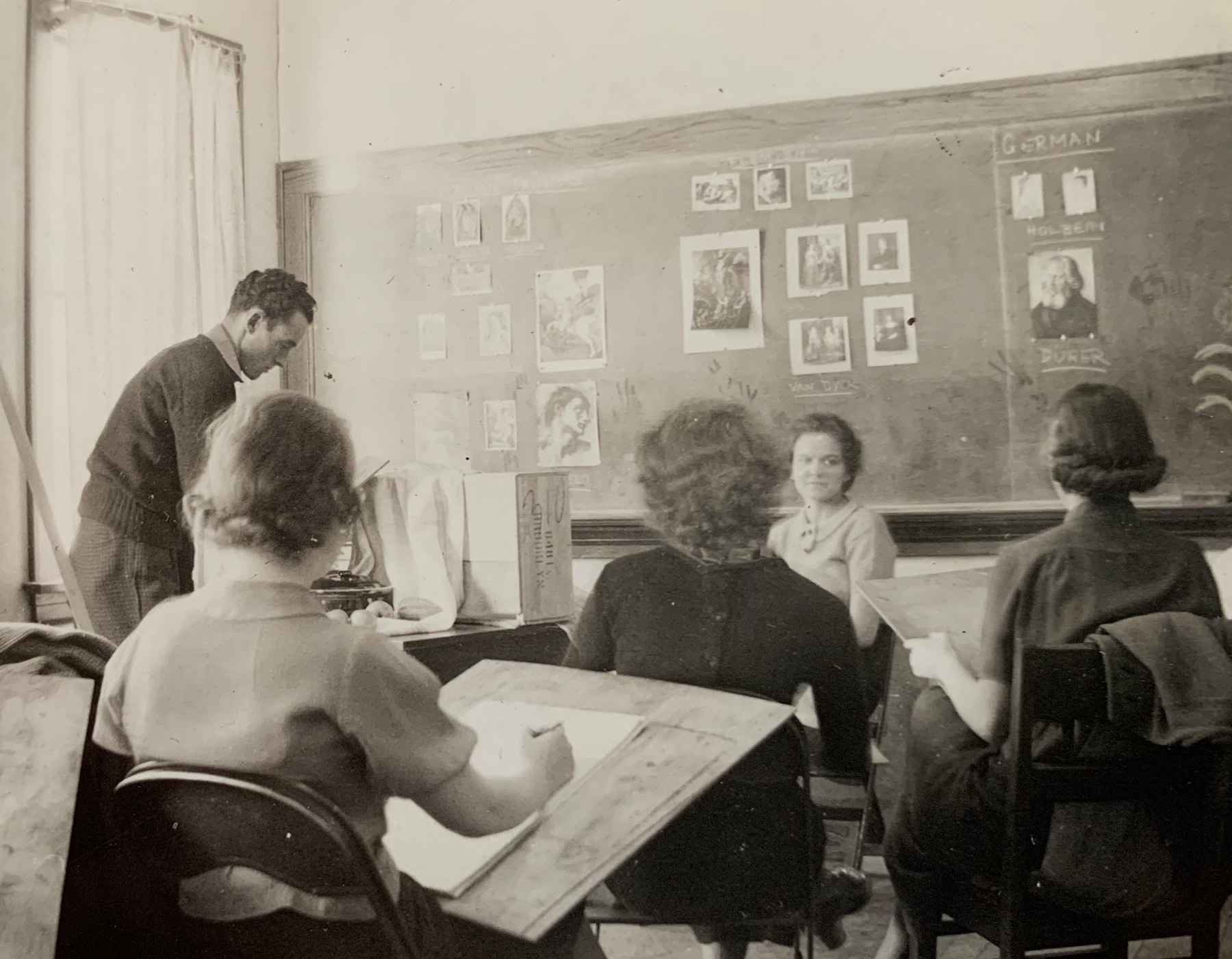 Black and white archival photograph of students drawing in an art class.
