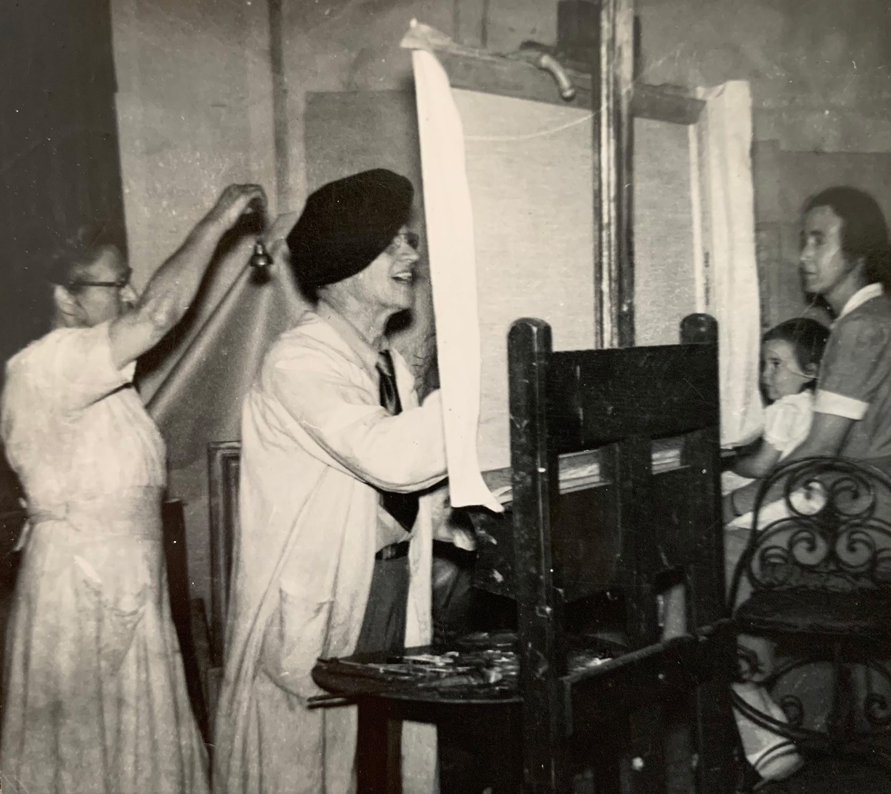 Historic photo of Ortlip family member painting at easel.