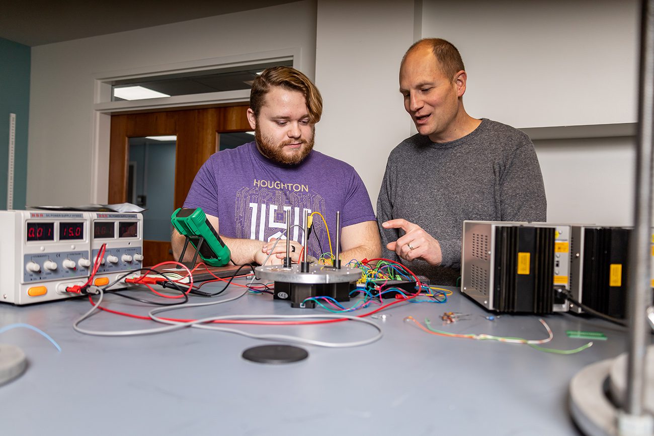 Houghton student working with professor in physics lab.