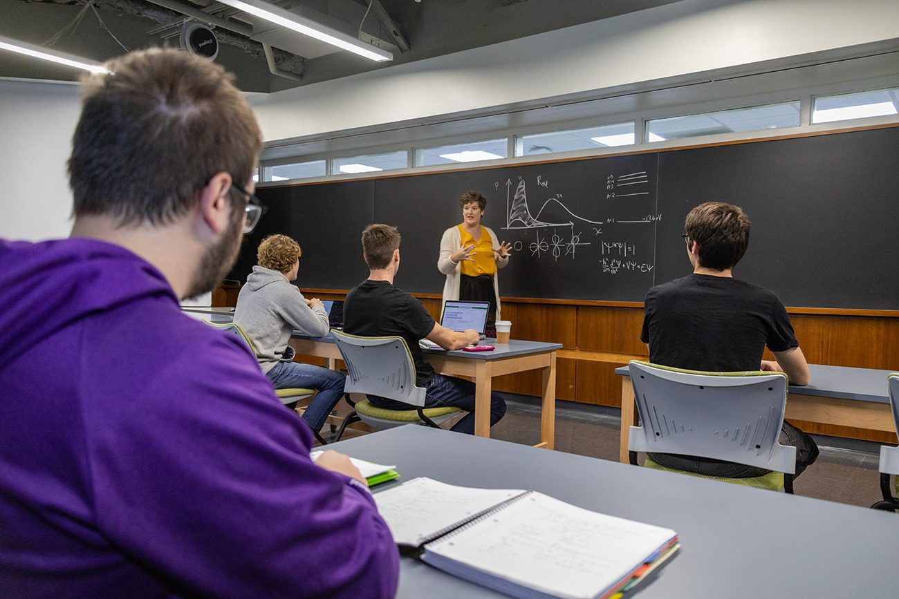 Houghton professor Katrina Koehler speaking to physics class.