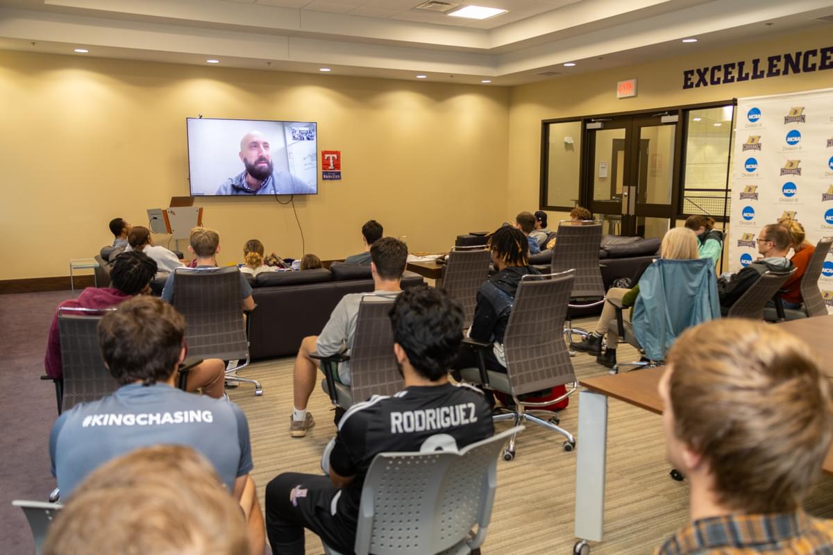 Adam Lewkowicz talking to students