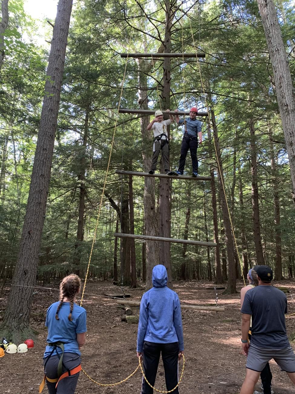 Houghton students standing on ropes course element during Highlander Wilderness Adventure.