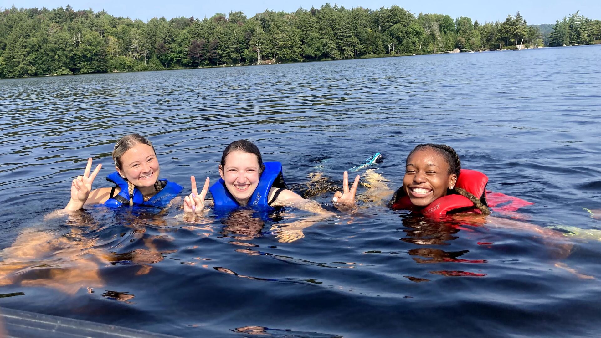 Students swimming in lake during Highlander Wilderness Adventure.