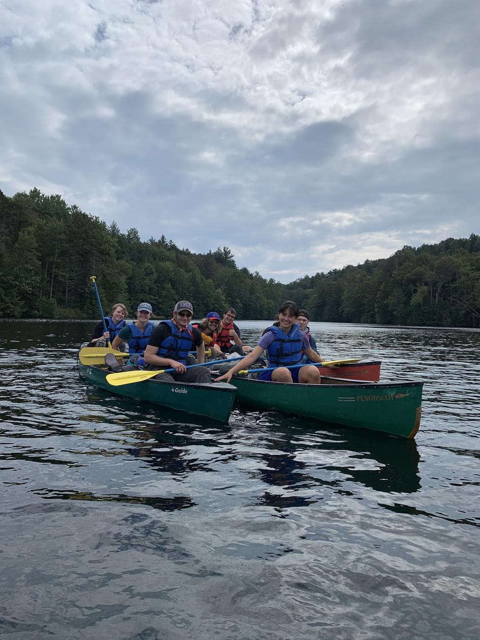 Students in canoes on a lake during Highlander Wilderness Adventure.