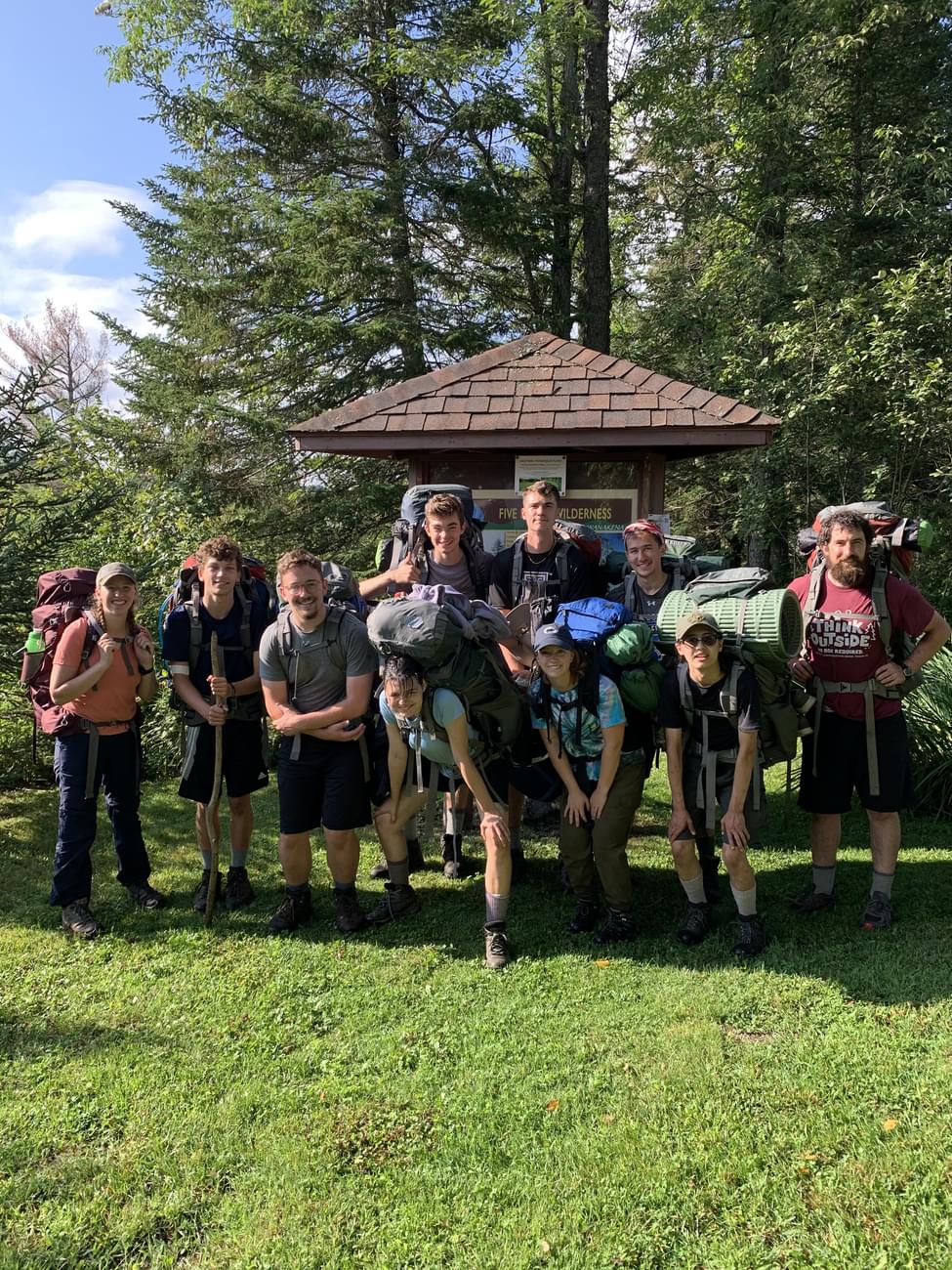 Houghton students standing together with backpack gear during Highlander Wilderness Adventure.