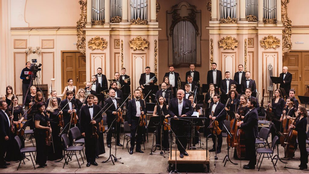 Lviv National Philharmonic Orchestra of Ukraine standing after performance.