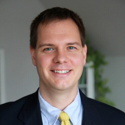 Matthew Soerens with blazer, blue shirt and yellow tie.