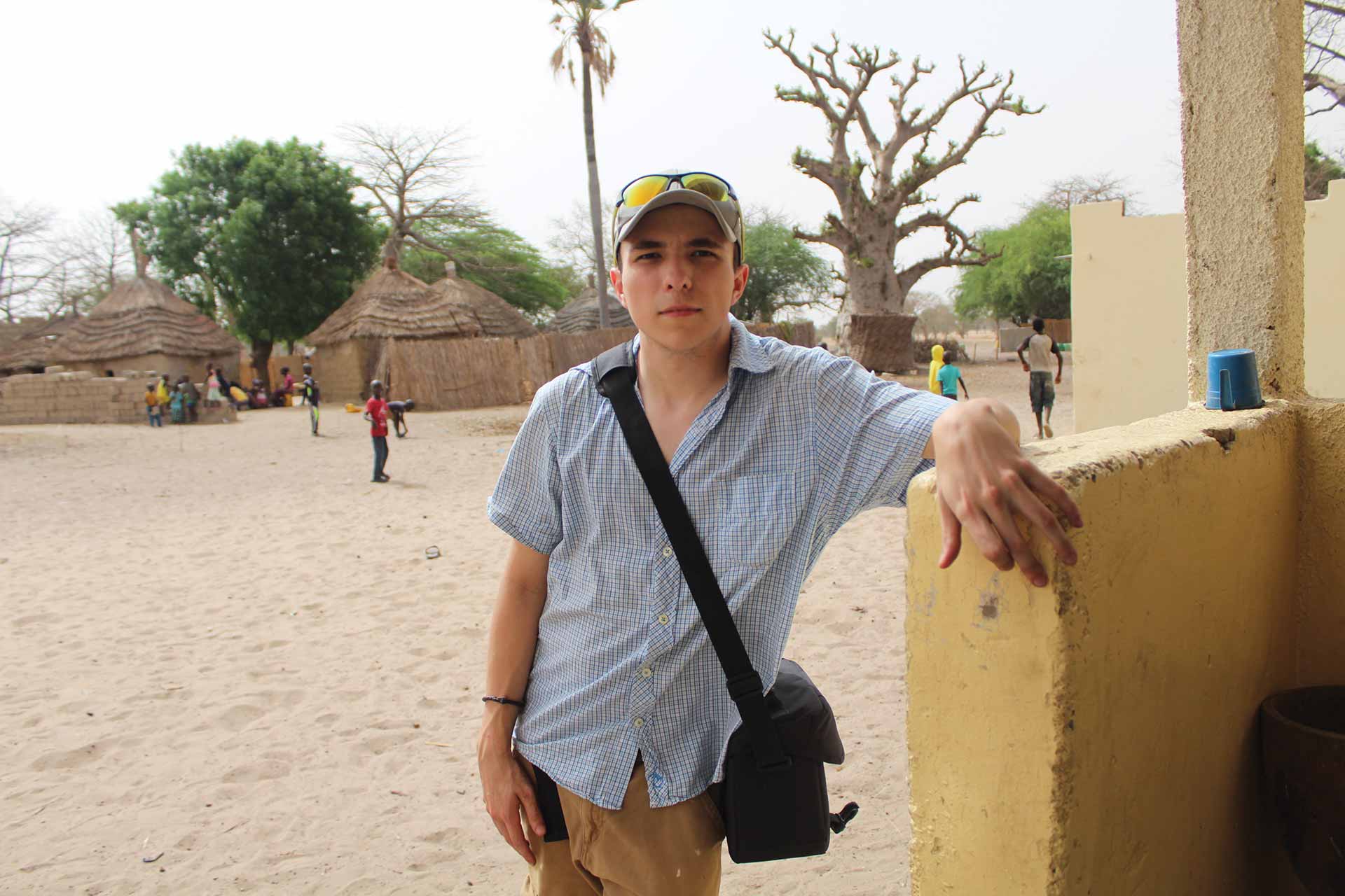 Houghton alumnus Jacob Kuhlkin standing by building when traveling abroad.