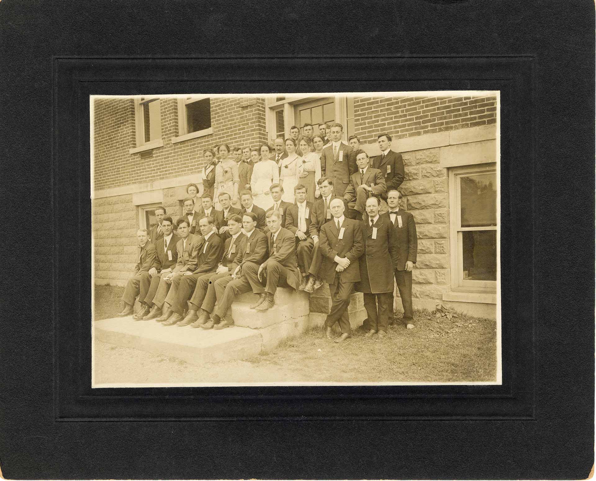 Archival photo showing Melvin Warburton with a group of students and professors.