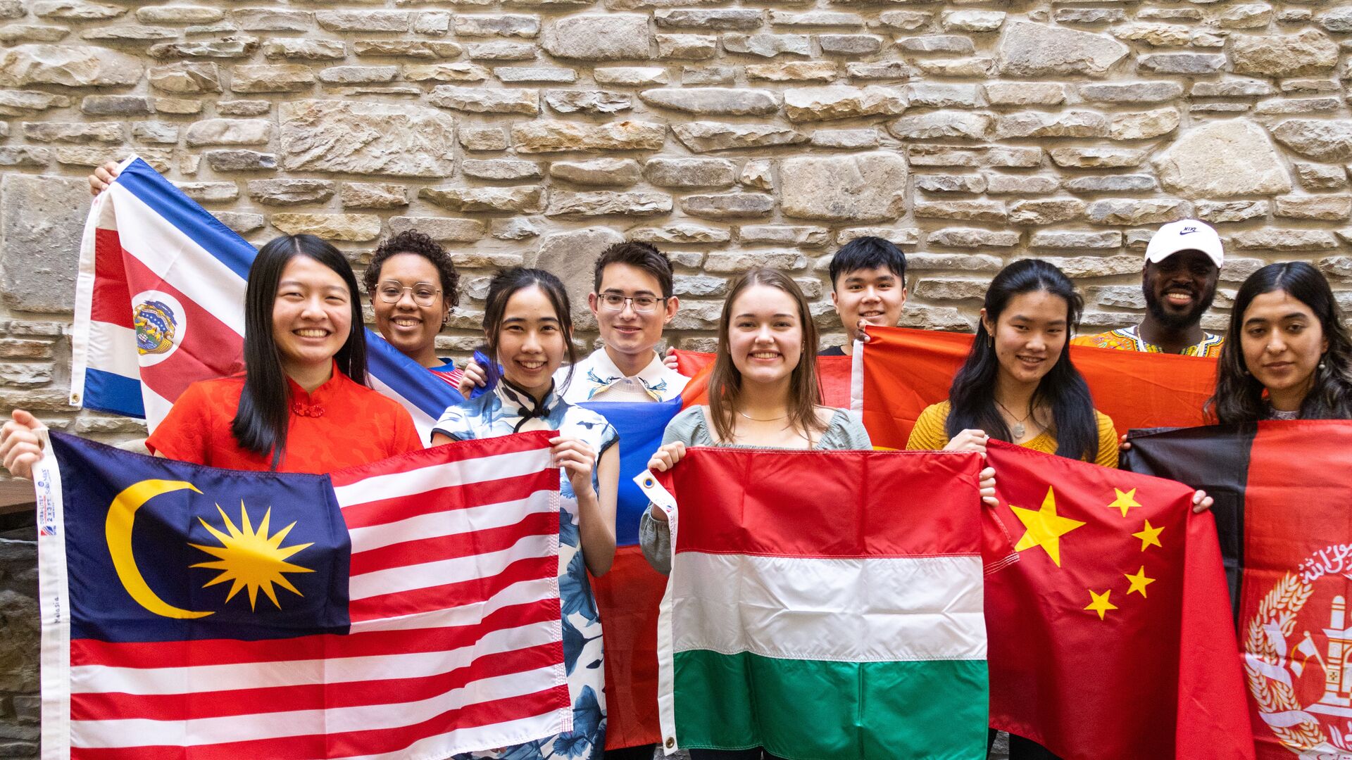 Houghton international students gathered together with flags from their home countries.