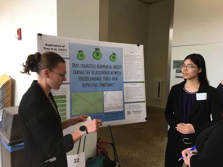 Two Houghton students presenting their psychology research poster board