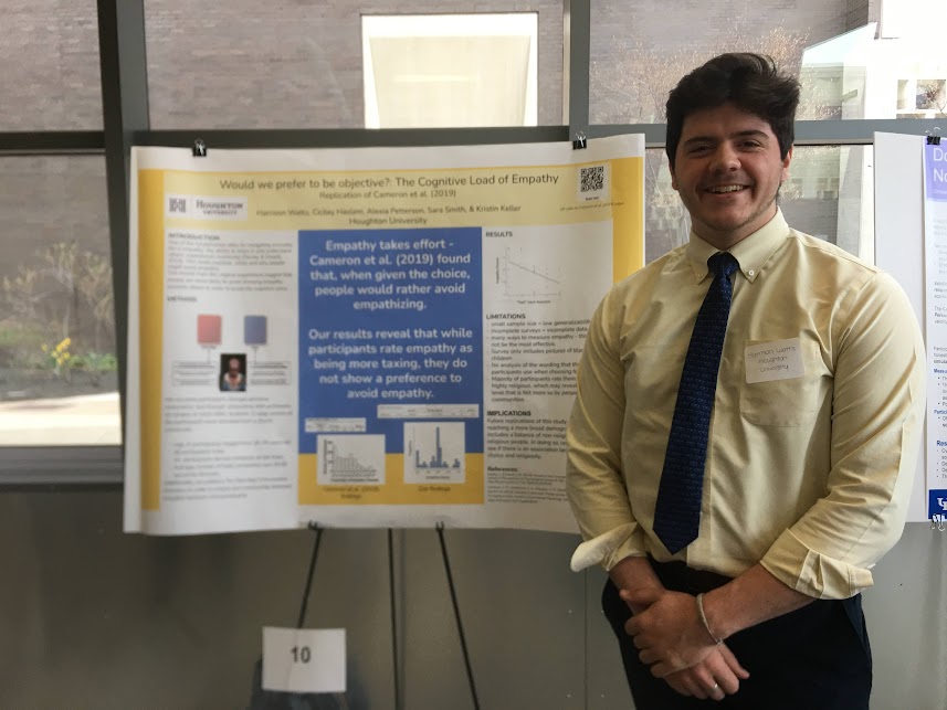 Houghton student presenting his research poster at psychology conference.