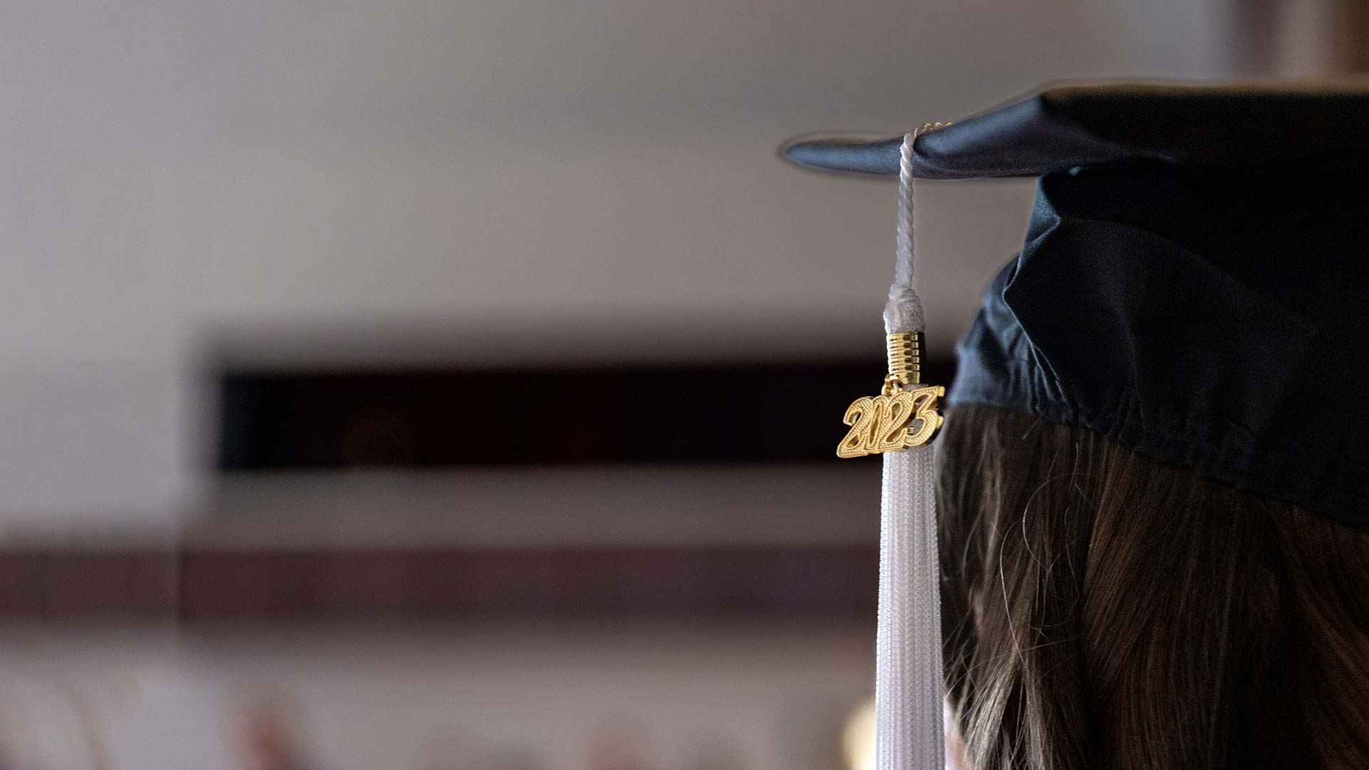 2023 pendant hanging from a graduate's tassel