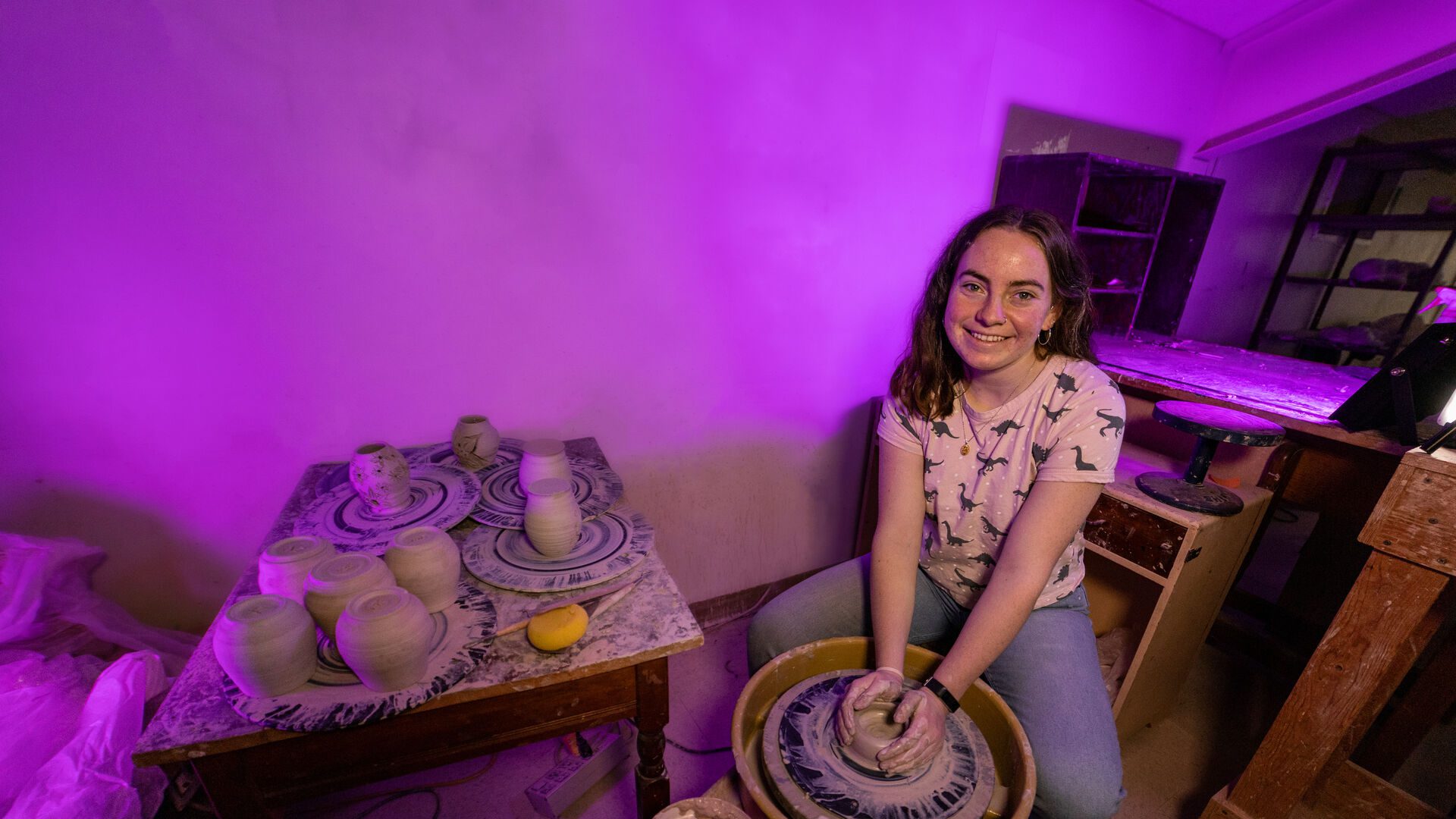Houghton student Alyssa Lyon at potter's wheel in the Stevens Art Studio.