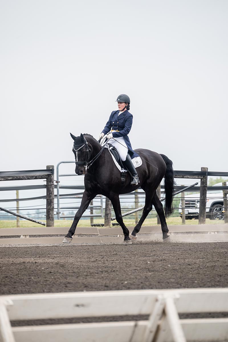 Houghton professor Larissa Ries riding horse at Equestrian Center.