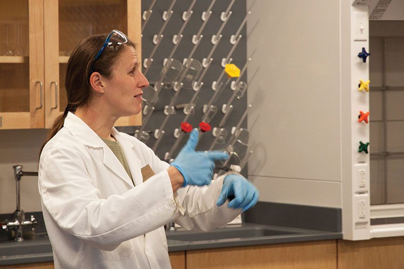 Houghton professor Karen Torraca giving demonstration in lab.