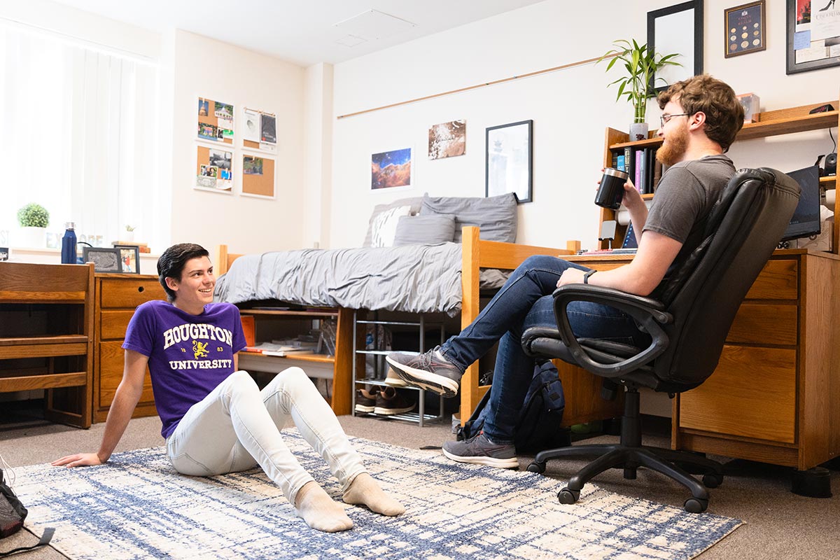 Two students talking to each other in their room in Rothenbuhler Hall at Houghton University.