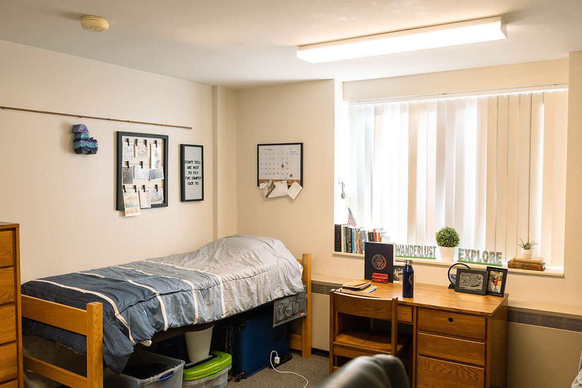 Rothenbuhler room with bed, desk, window and decorations at Houghton University.