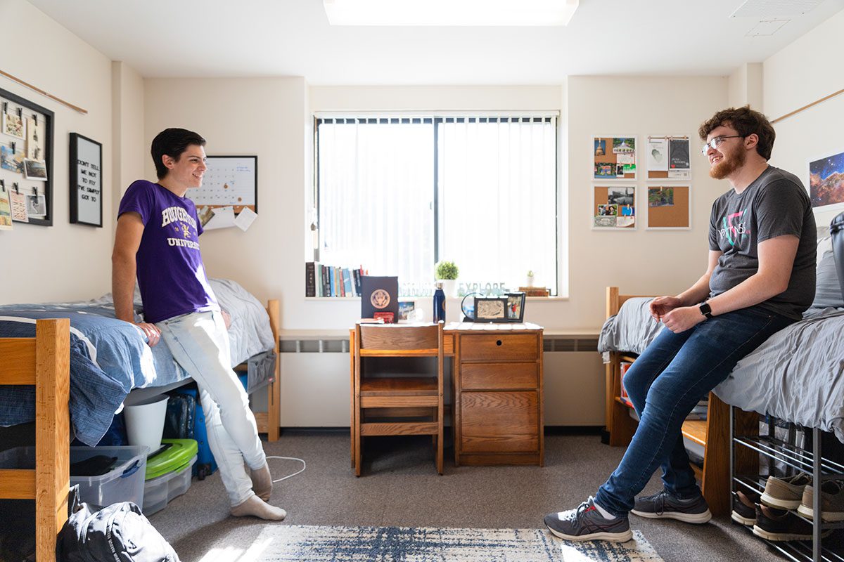 Two students talking to each other in their room in Rothenbuhler Hall at Houghton University.