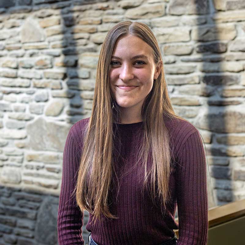 Houghton student Anna Lloyd with maroon sweater.