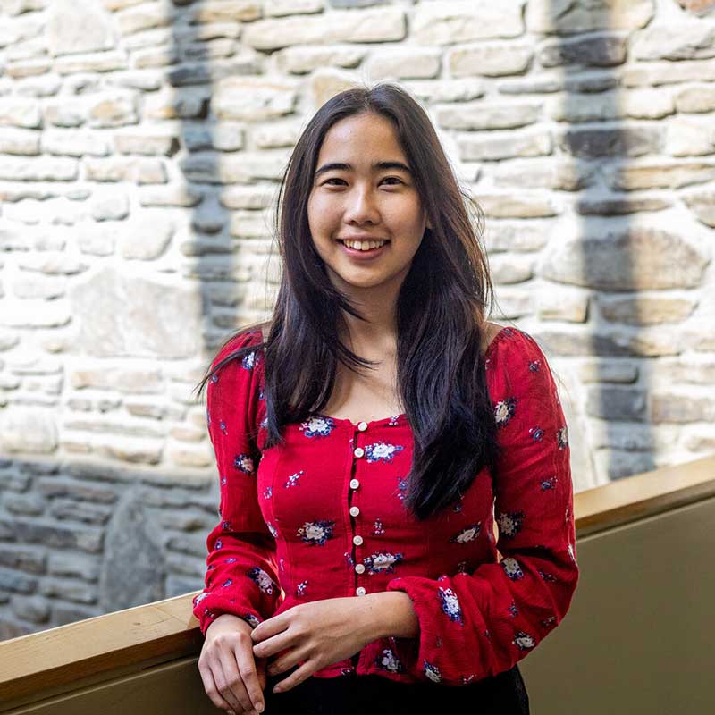 Houghton student Hannah Seow wearing red pattern long sleeve shirt.