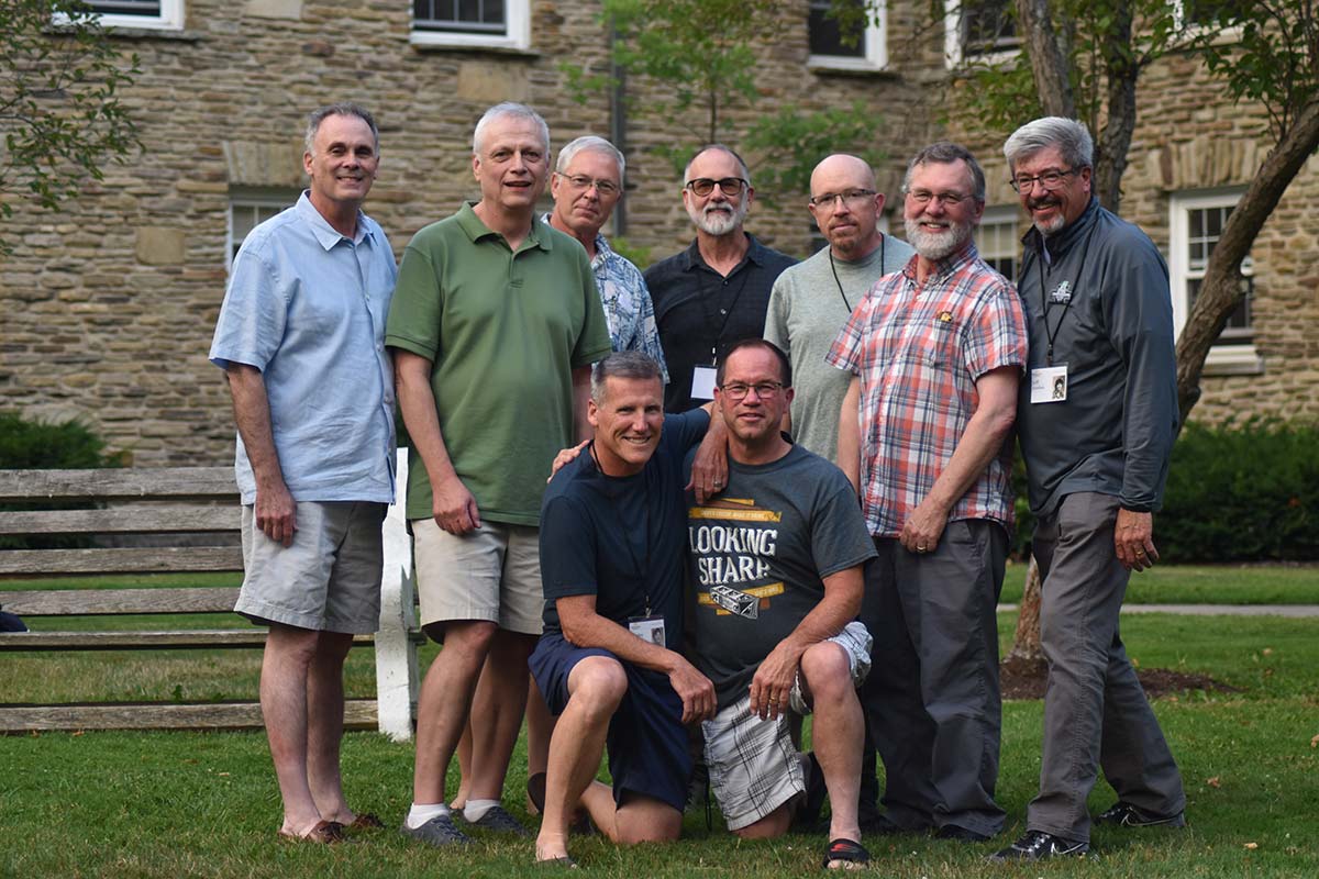 A group of Houghton alumni standing on campus lawn at the summer alumni reunion.