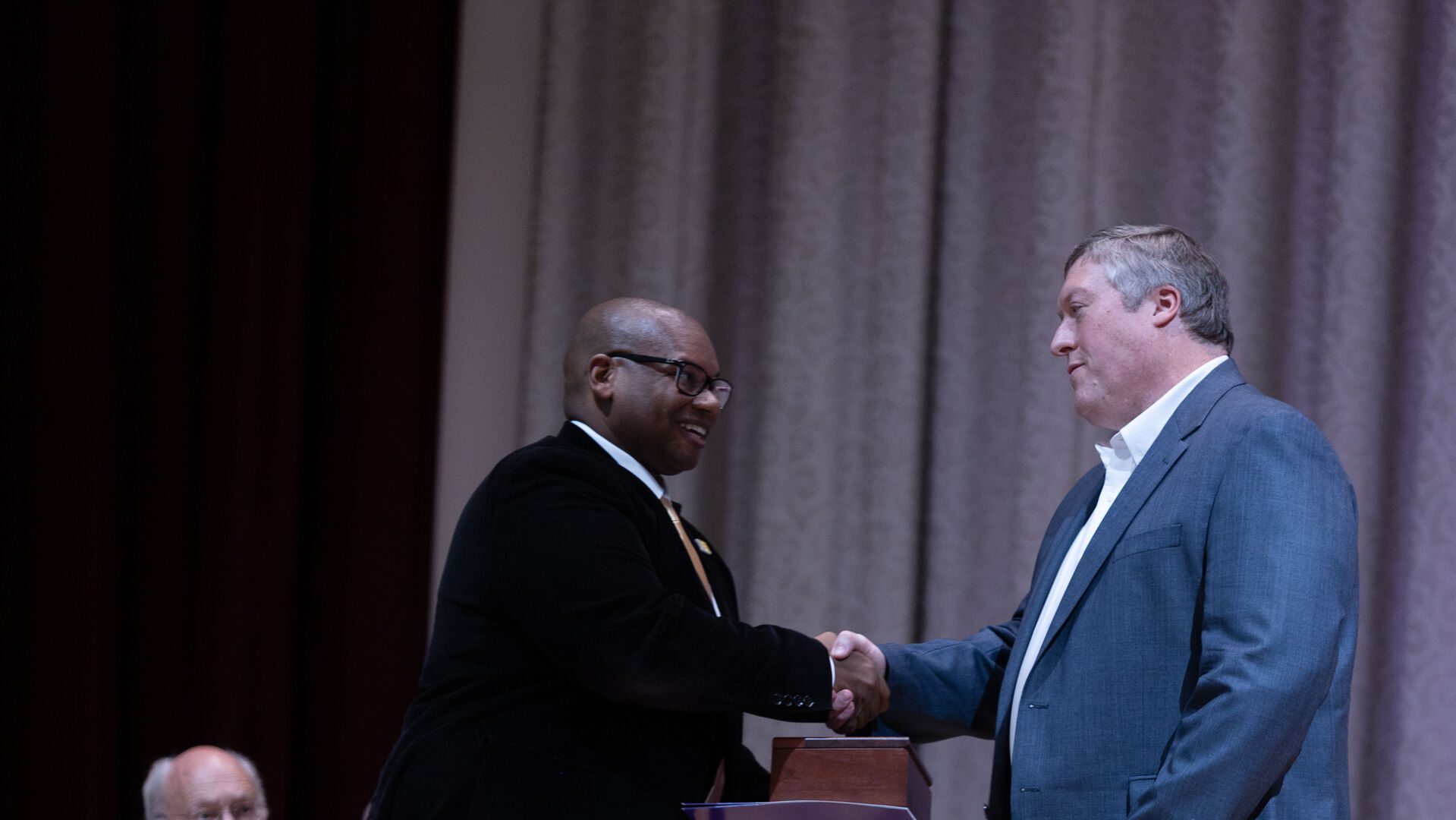 Houghton alumnus Timothy Deckert receive award from President Lewis.
