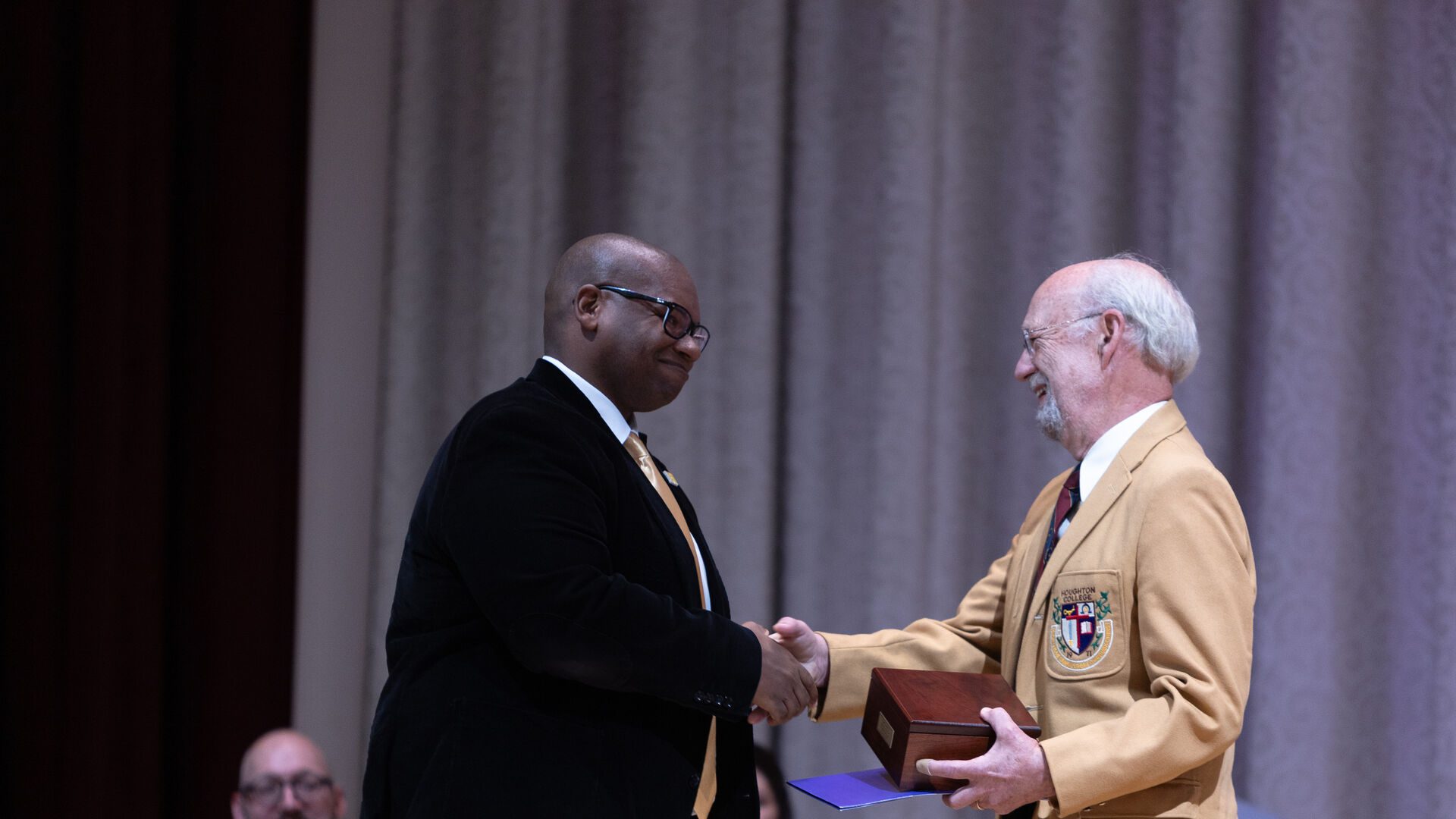 Houghton alumnus Dr. Carl Lynch receiving award from President Lewis.