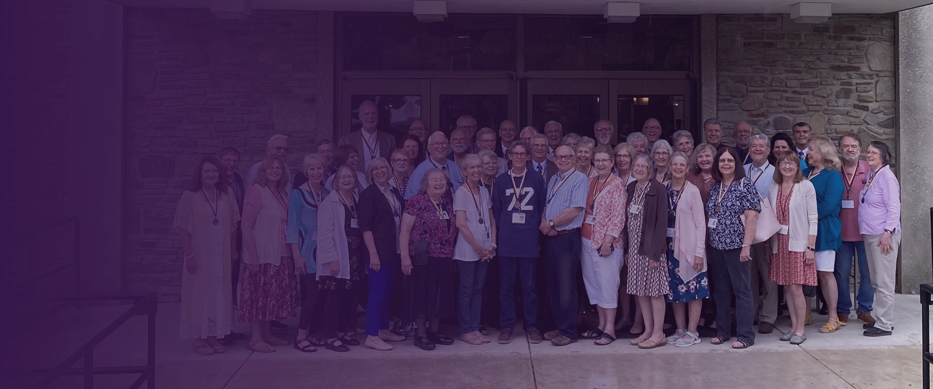 Houghton Class of 1972 standing together in front of the Campus Center.
