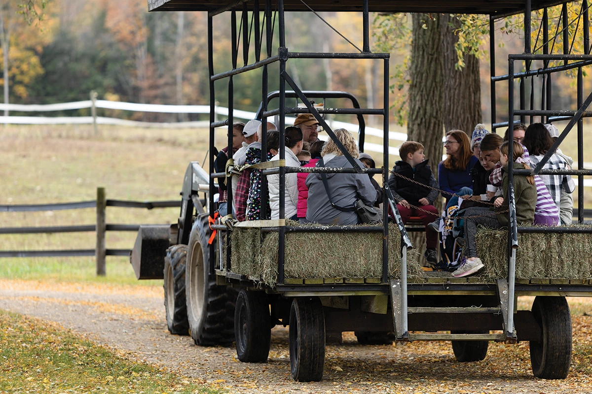 Houghton alumni and their families on tractor hayride.